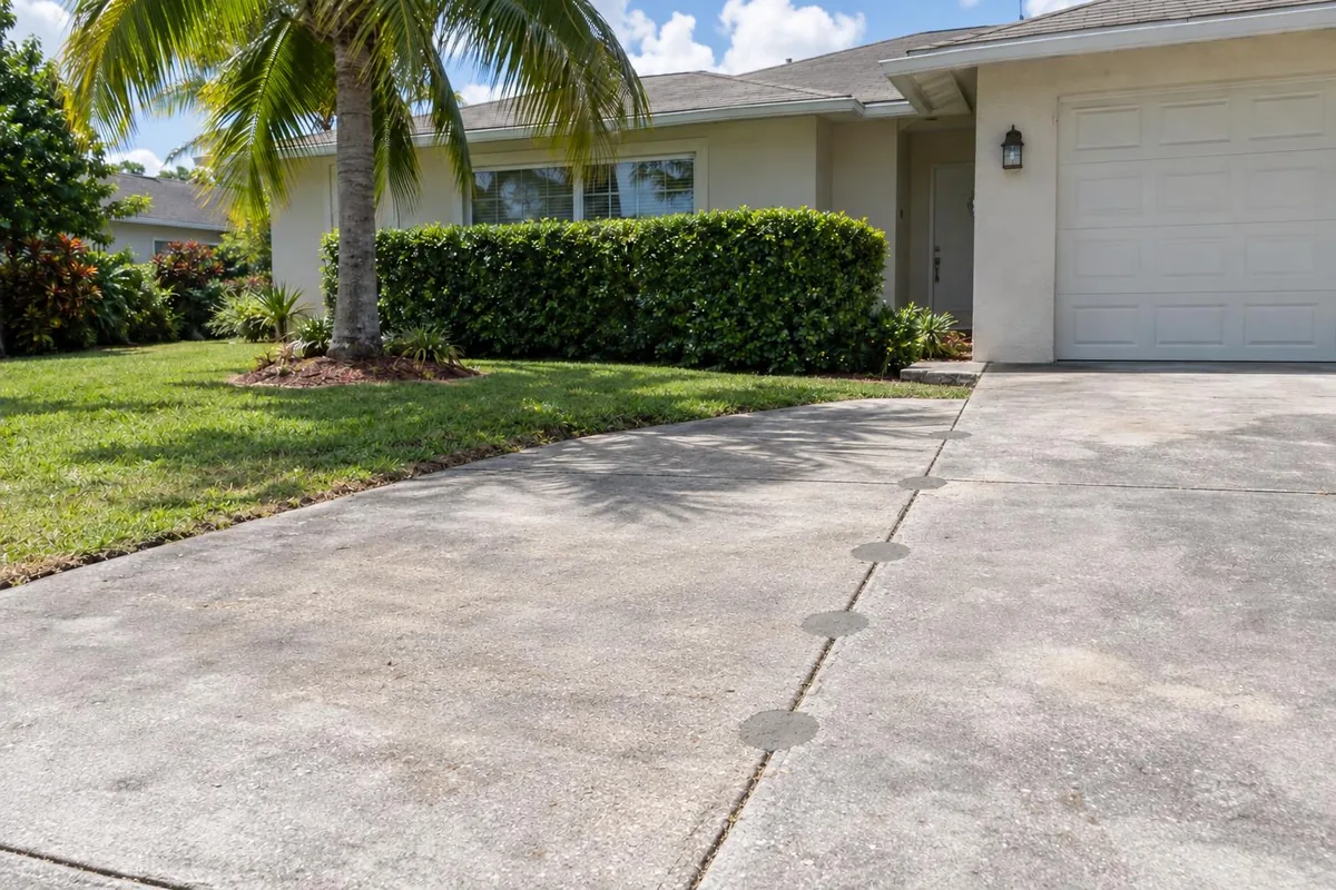 The same driveway after leveling, with the slabs flush and a smooth seam