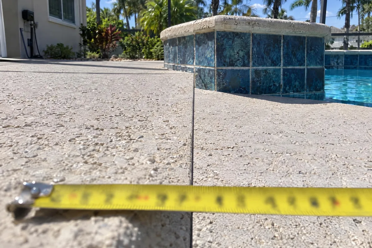 The pool deck after leveling, sitting level against the coping